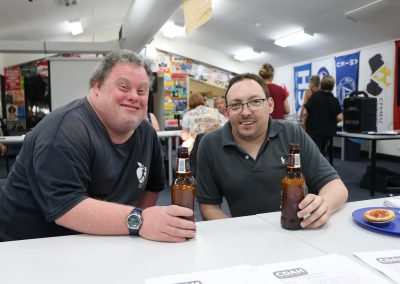 Leigh Creighton and David Belcher smiling while drinking a beer