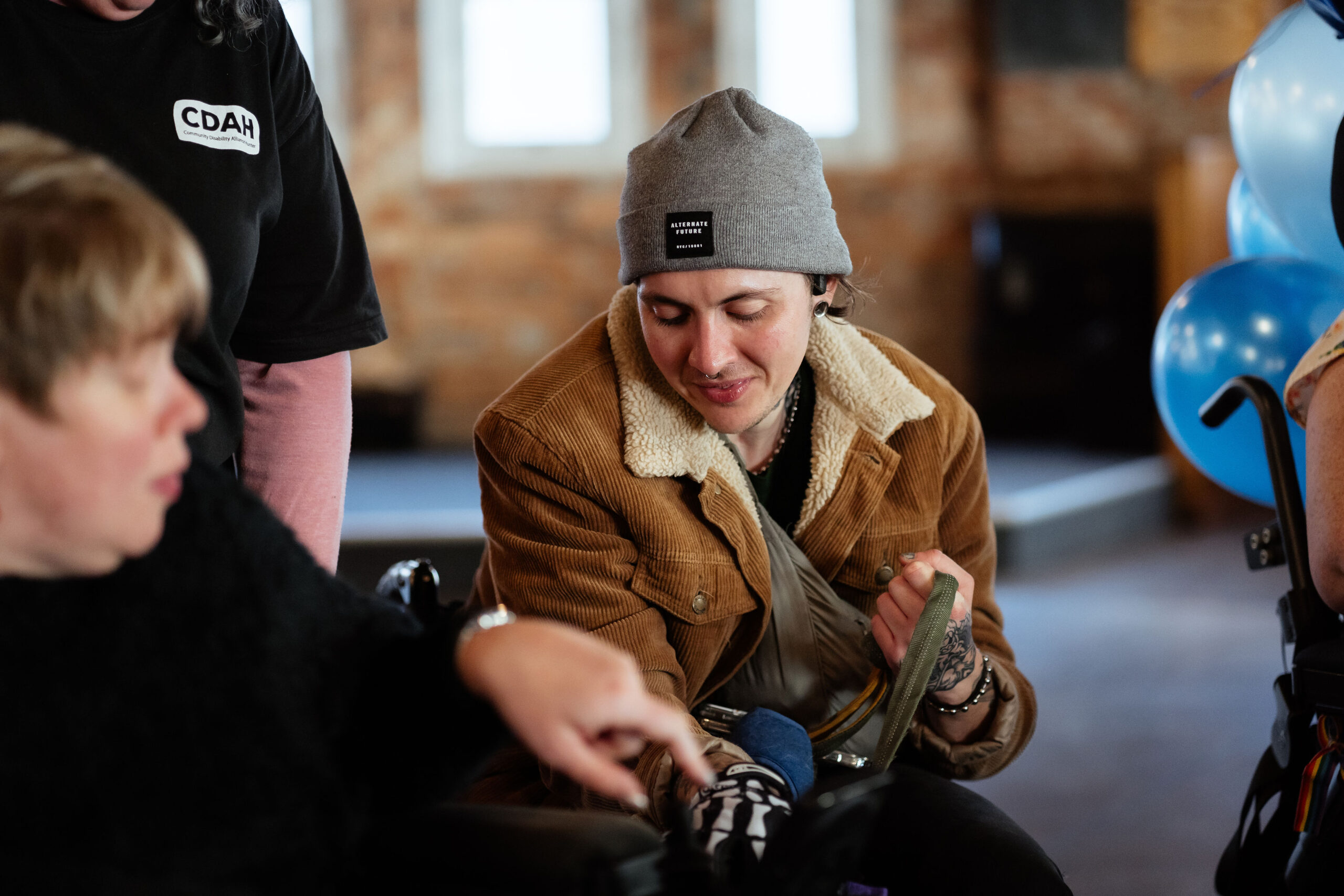 Image description: CDAH peer sitting indoors