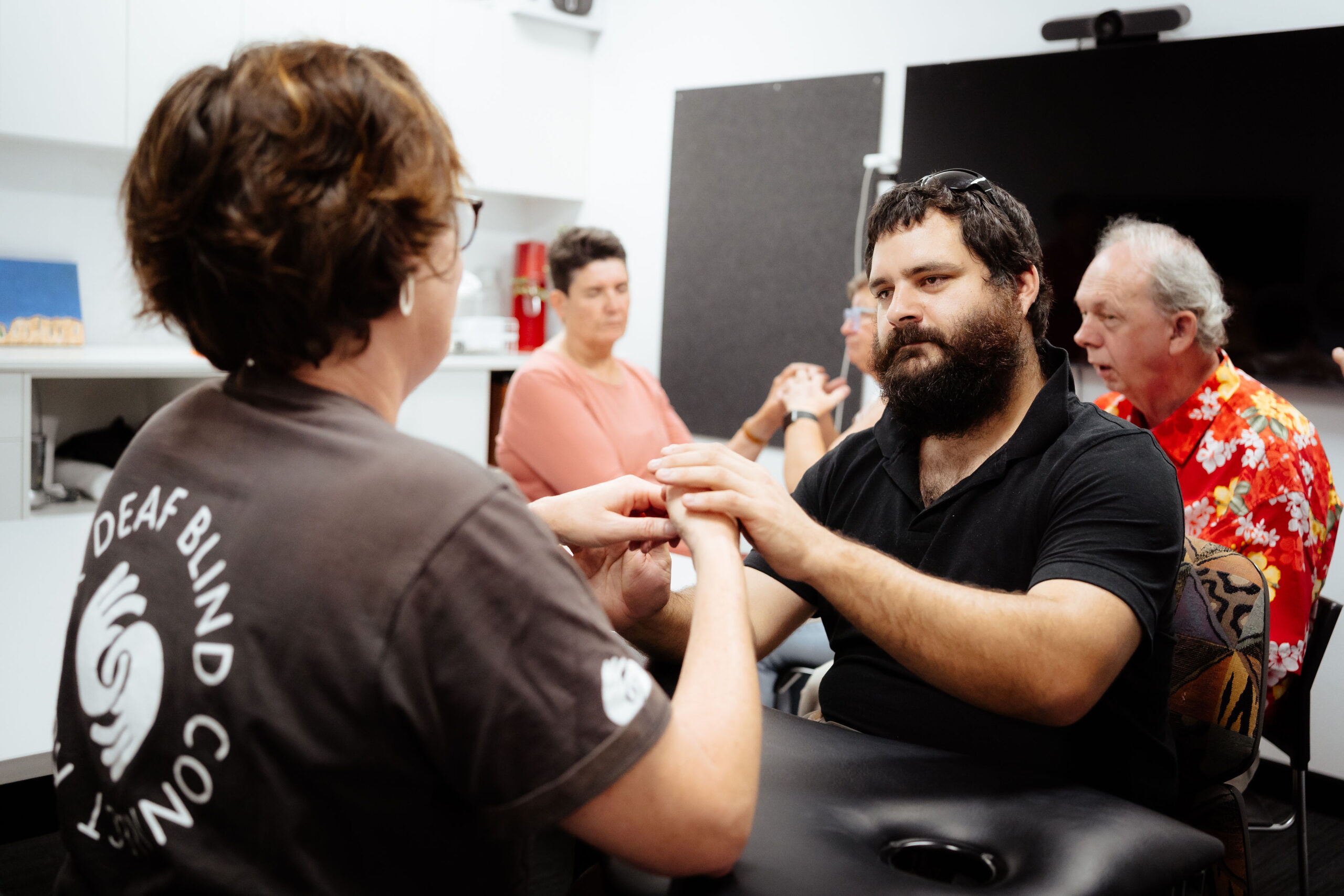 Image description: Jex working with an interpreter during Deafblind Hub