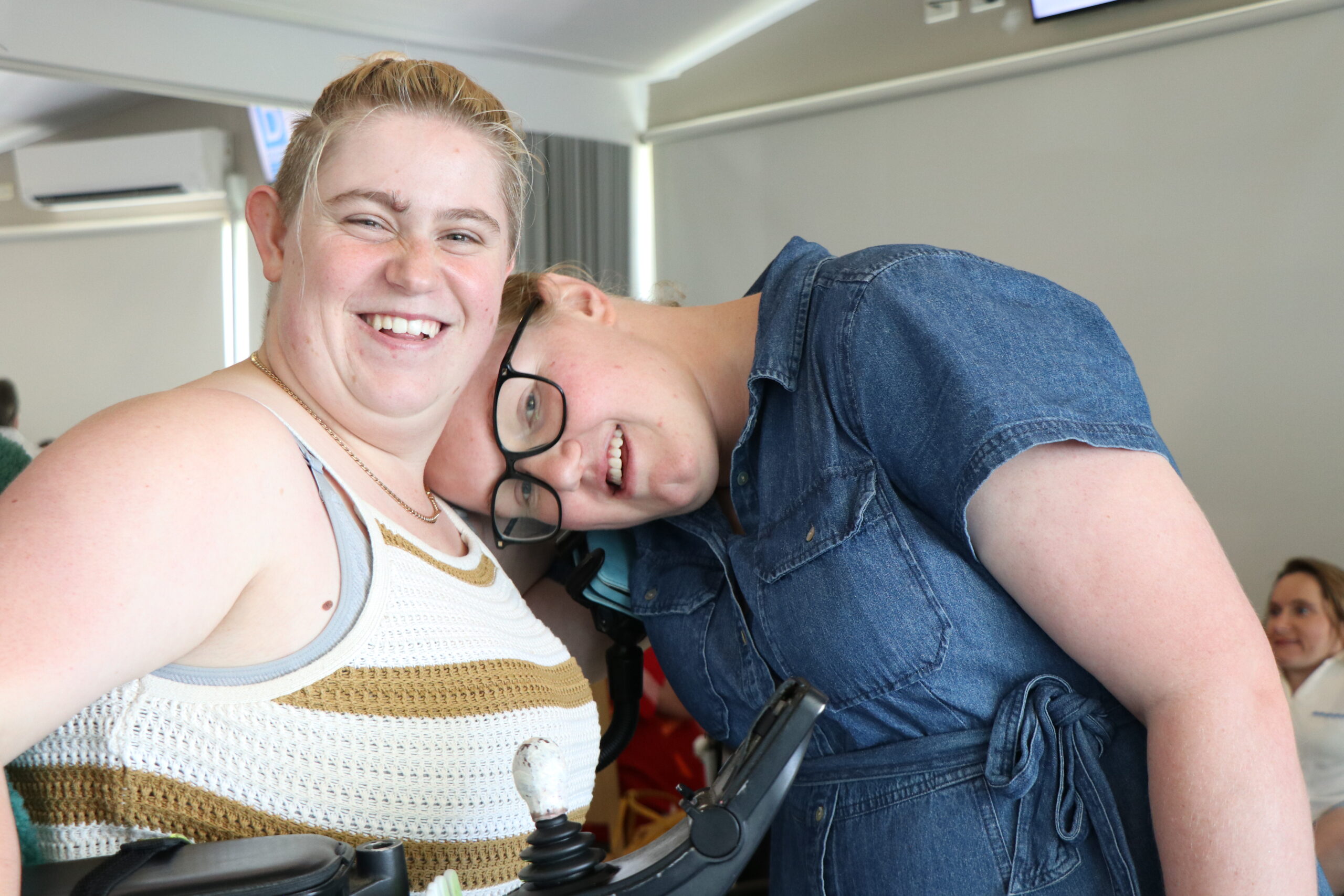 Image description: Two CDAH peers posing and smiling together